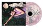 Text: "Pixie". Eine Frau in einem lilafarbenen Kleid liegt auf Rasen. Daneben eine stilisierte CD.