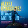 „Alexej Gerassimez, Black Mountain, NDR Radiophilharmonie, Gordon Hamilton.“ Ein Mann balanciert mit Schlegeln am Meer.