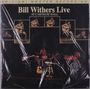 „Bill Withers Live at Carnegie Hall“. Mehrere Fotos eines Musikers und einer Band auf der Bühne.