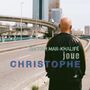 Texte: "BACHAR MAR-KHALIFÉ joue CHRISTOPHE". Eine Person von hinten, mit Glatze, vor einer Stadtkulisse.