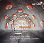 "out into the open" und "trio accanto" sind zentrale Texte. Grauer Tunnel mit runden Tischen und orange beleuchteten Öffnungen.