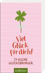 "Viel Glück für dich!" und "24 kleine Glücksbringer". Ein grünes Kleeblatt auf rosa Hintergrund. Ein Logo unten.