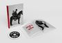 „HOW'S IT GOIN'“ steht auf einem Buchrücken und einer CD. Daneben ein offenes Buch mit Schwarz-Weiß-Fotos.