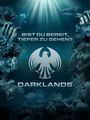 Text: "Bist du bereit, tiefer zu gehen? Darklands." Ein stilisiertes Adler-Logo. Unterwasserlandschaft mit Korallen und Fischen.