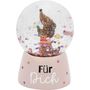"Für Dich" steht auf einem Sockel. Darauf eine Glaskugel mit einem bunten Tier, das eine Blume hält, umgeben von Glitzer.