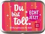 Text: "Du bist toll. ECHT JETZT. 25 Komplimente für dich." Hintergrund: Pink mit Streifen und Sternen.