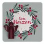 Text: "Von Herzen". Illustration: Ein Kranz aus Blättern und Beeren mit einem kleinen Engel in Rot.