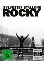 Text: "SYLVESTER STALLONE ROCKY", "FSK ab 12 freigegeben", "4K Ultra HD". Szene: Person hebt triumphierend die Arme auf einer Treppe.