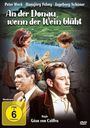 „An der Donau, wenn der Wein blüht“ steht oben. Im Vordergrund sind drei Personen, dahinter eine malerische Landschaft.
