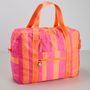 Text "Loden" auf einem Etikett. Bunte Tasche in Pink- und Orangetönen mit Schulterriemen und Reißverschlusstasche.