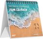"Der kleine Kalender zum Lächeln 2027". Illustration eines Strandes mit Wellen und Fußabdrücken im Sand.