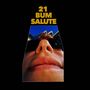 Text: "21 BUM SALUTE". Nahaufnahme eines Gesichts mit Sonnenbrille, im Hintergrund moderne Architektur.