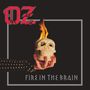 Text: "OZ" und "FIRE IN THE BRAIN". Illustration von Hand hält brennenden Totenkopf, schwarzer Hintergrund.