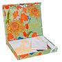 Eine bunte Box mit Blumenmuster, darin Notizblöcke. Text: "Eine Blume blüht für jeden, der Zeit hat, sie zu betrachten."
