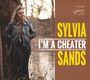 Sylvia Sands, I'm a Cheater. Frau in Lederjacke lehnt an Baum. Hintergrund ist ein Wald mit Wasser.