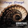 "Strange Enough" oben, "Downstairs Singles & Remixes" unten. Spiralförmige Treppe von oben betrachtet.