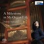 "A Milestone in My Organ Life" Yukiko Yamada. Logo oben rechts. Frau vor einer großen Orgel.