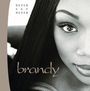 Text: "NEVER SAY NEVER" und "brandy". Nahaufnahme einer Frau mit glattem Haar und ausdrucksstarken Augen.
