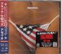Das Bild zeigt den Text "amorica." und enthält japanische Schriftzeichen. Ein Slip mit US-Flaggenmuster ist sichtbar.