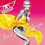 „Just push play“ steht in geschwungener Schrift. Eine futuristische, metallische Figur mit gelbem Kleid, heller Hintergrund.