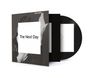 Text "The Next Day" zentral auf weißem Quadrat. Schwarz-weiße Fotografie im Hintergrund, CD leicht herausgezogen.