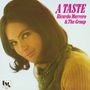 Text: "A TASTE Ricardo Marrero & The Group". Eine Frau mit langen dunklen Haaren lächelt sanft, trägt ein gelbes Oberteil.