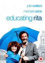 „Julie Walters, Michael Caine, Educating Rita“ – Fröhliche Frau mit lockigem Haar unter blauem Regenschirm, Mann daneben.