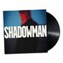 "SHADOWMAN" steht groß auf einem Albumcover. Ein unscharfer, rotblauer Schattenriss eines Mannes ist im Hintergrund.