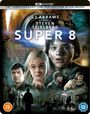 Text: "15TH ANNIVERSARY LIMITED EDITION STEELBOOK", "J.J. ABRAMS", "STEVEN SPIELBERG", "SUPER 8", "DINER". 

Vordergrund: Verschiedene Figuren, Explosion im Hintergrund.