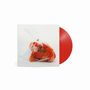 Kein Text erkennbar. Ein rotes Vinyl und ein Plüschtier in einem Plastikbeutel auf weißem Hintergrund.