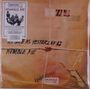 Texte: "AS SAFE AS YESTERDAY IS", "HUMBLE PIE", "FRAGILE WITH CARE". Design: Paket mit Siegel und Kordel.