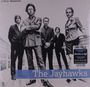 "2 Meter Sessions. The Jayhawks." Fünf Personen in formeller Kleidung stehen auf einem Holzboden.