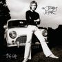 "THE JOURNEY... SO FAR", "Mike d’Abo". Schwarz-Weiß, Person lehnt an einem klassischen Auto.