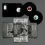 Vinyl-Schallplatten, geometrische schwarz-weiße Motive, sie sind auf einer grauen Oberfläche angeordnet.