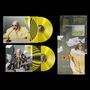 Zwei gelbe Schallplatten mit Hüllen. Cover zeigen Person in auffälligem Outfit mit Brille. Texte: „DIGITiSE“, „Humanize“.