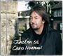 "Junction 55 Chris Norman" steht in weißer Schrift; ein Mann mit braunen Haaren und Bart trägt einen Mantel und schaut zur Seite.