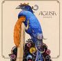Text: "AGUSA PANACEA". Eine Illustration zeigt eine Frau mit rotem Haar neben einem großen, blauen Vogel mit Krone.