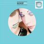 Text oben: KOOP Koop Islands. Rechts: 2026 Re-Issue, featuring extra track Strange Love. Zwei Gesichter mit buntem Makeup.