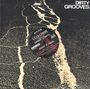 "Keep It Real" von LTJ & Chris feat. Danny Losito. Ein runder Aufkleber auf einer rauen, rissigen Oberfläche. Oben das Logo "Dirty Grooves".