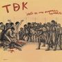 Text: "TDK", "esto es una empresa capitalista".  
Illustration zeigt Menschen, die von Soldaten bedroht werden.