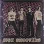 „Supersonic Rock Saga“ steht vertikal; unten „Sick Shooters“. Vier Personen vor einem pink-schwarzen Gitterhintergrund.