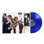 "Cheap Trick: Next Position Please" steht auf einem Album-Cover mit einer Gruppe von Personen und einer blauen Schallplatte.