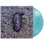 Ein violetter Sarg in Form eines Raumschiffs bricht durch eine gemusterte, grau-bunte Oberfläche. Türkise Vinyl-Schallplatte.