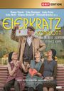 "Eierkratz Komplott" und "Ein Stinatz Krimi" in gelber Schrift. Drei ältere Frauen auf einer Bank, ein Mann in Tracht davor.