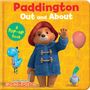 "Paddington Out and About. A Pop-up Book." Illustration eines Bären in blauem Mantel und rotem Hut mit Ballon und Taube.
