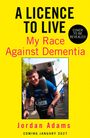 „A Licence to Live: My Race Against Dementia“ von Jordan Adams. Freudiger Mann trägt große Box. Veröffentlichung Januar 2027.
