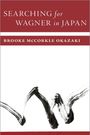 "SEARCHING for WAGNER in JAPAN" oben. "BROOKE MCCORKLE OKAZAKI" darunter. Schwarze Pinselstriche auf weißem Grund.