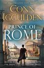 Der Text zeigt: "The Multimillion-Copy Bestseller", "Conn Iggulden", "PRINCE OF ROME", "Power is the Prize", "Rome Sets the Price". Eine Person steht vor antiken römischen Gebäuden.