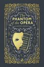 „The Phantom of the Opera“, Gaston Leroux. Vergoldete Maske, Notenblätter, dekorative Verzierungen.