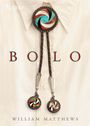 Text: BOLO, William Matthews.  
Unter einem Bolo-Tie-Design auf einem Hemd.